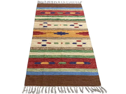 Beige kilim with colorful stripes and star/diamond motifs, fringes