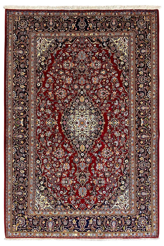 Keshan rug with a red central medallion, dark border, and decorative vines, flat-weave