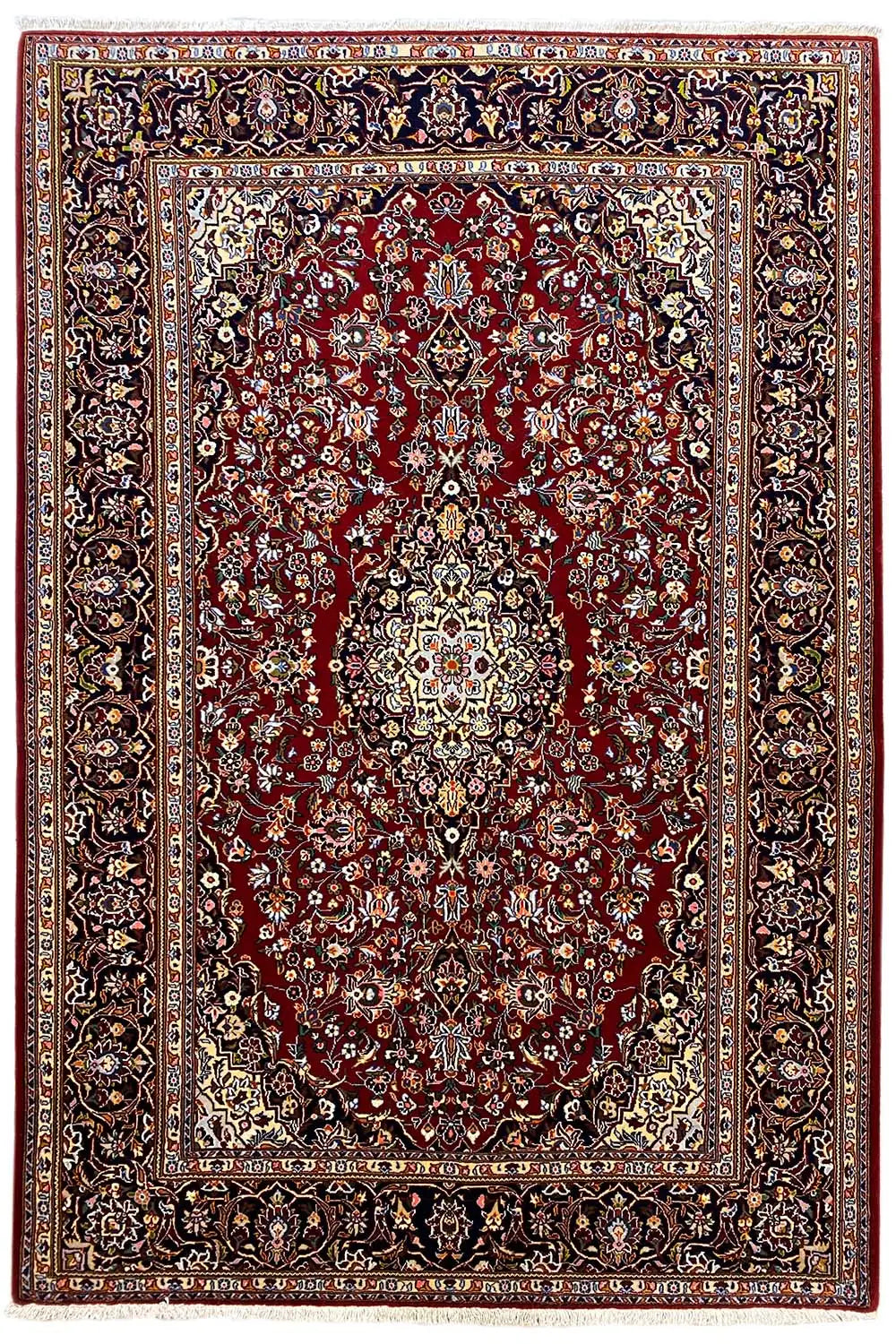 Keshan rug with a red field, central medallion, and wide dark patterned border.