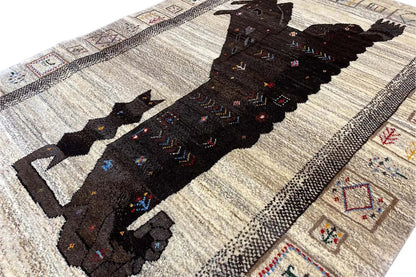 Gabbeh rug detail: black lion motif with colorful embellishments