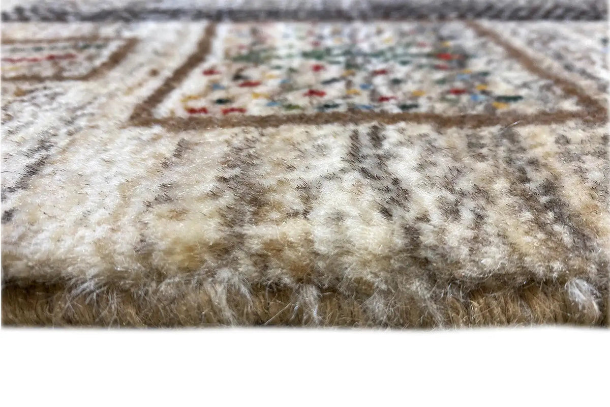 Gabbeh rug close-up: pile texture and bound edge with multicolored grain pattern