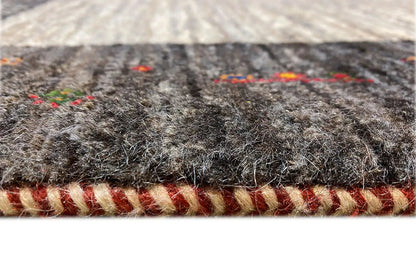 Gabbeh rug edge detail with fringed finish and dark border trim