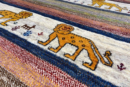 Detailed view: lion figures on a light background between colored stripes, fine woven texture