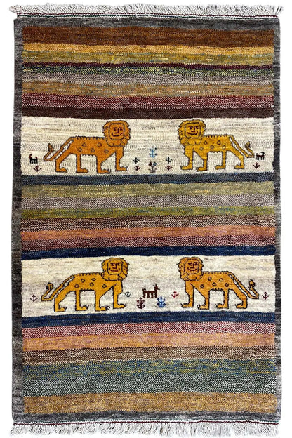 Gabbeh rug with multicolored stripes, lion motifs in the central field, and fringes