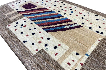Gabbeh rug 121x83 cm close-up: stripes, dots, and beige shading in a grid