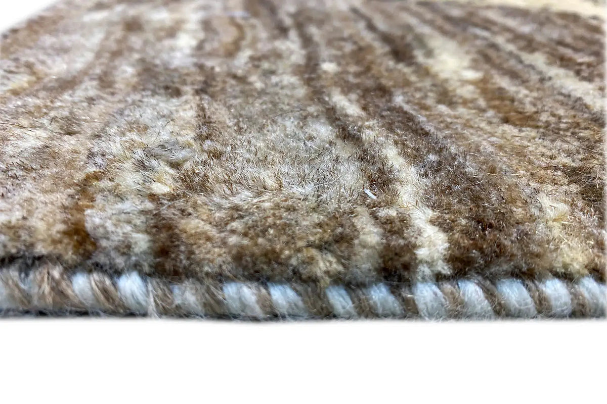 Rug edge with short pile, multicolored pattern in brown, beige, and yellow