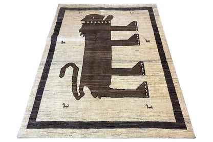 Flat Gabbeh rug, large animal/arrow central motif, light beige and dark brown, framed in black