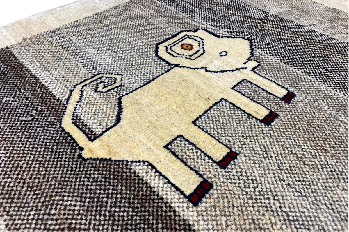 Close-up: Gabbeh rug with a lion motif in light and dark tones