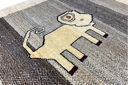 Close-up: Gabbeh rug with a lion motif in light and dark tones