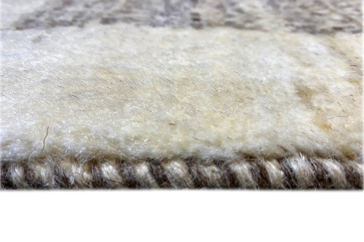 Gabbeh rug edge view with dense pile structure, light beige and dark gray fibers