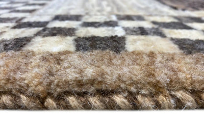 Carpet pile in detail: beige-brown fibers with dark stripes, short and dense