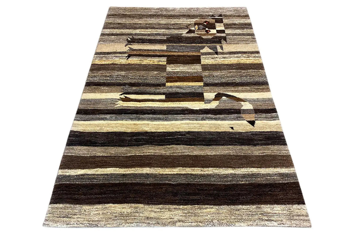 Triangular Gabbeh rug with stripes in dark brown, beige and gray.