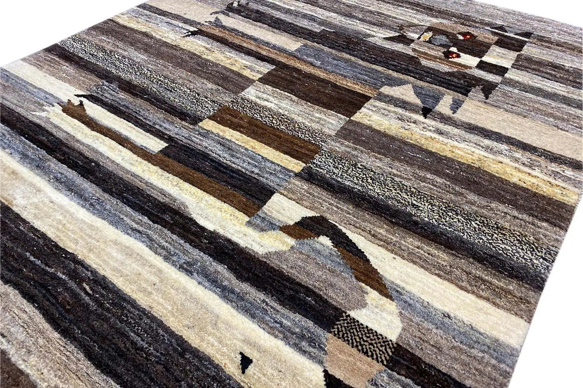 Close-up of a Gabbeh rug with multiple stripe layers and a lion motif in the pattern.