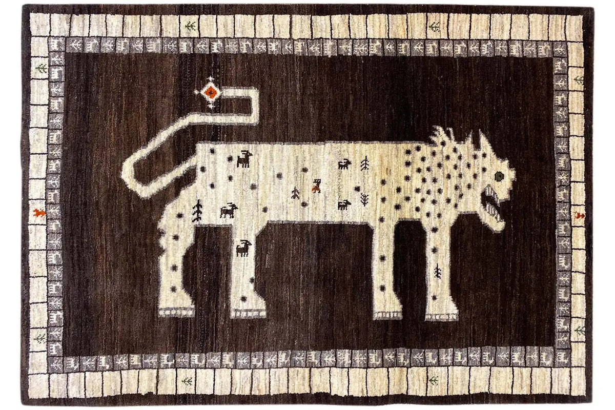 Gabbeh rug with lion motif, brown field, beige frame, and border pattern