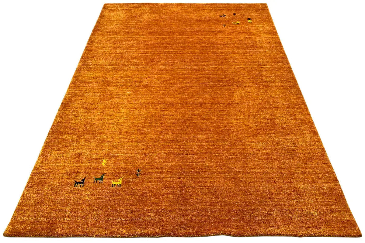 Honey-brown Gabbeh rug with animal motifs, trapezoidal in perspective