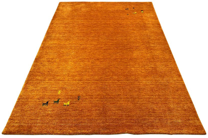 Honey-brown Gabbeh rug with animal motifs, trapezoidal in perspective