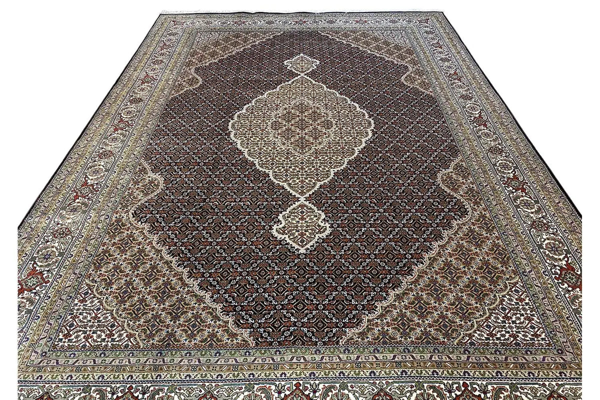 Indo Tabriz rug, full view with a large medallion and richly ornamented border