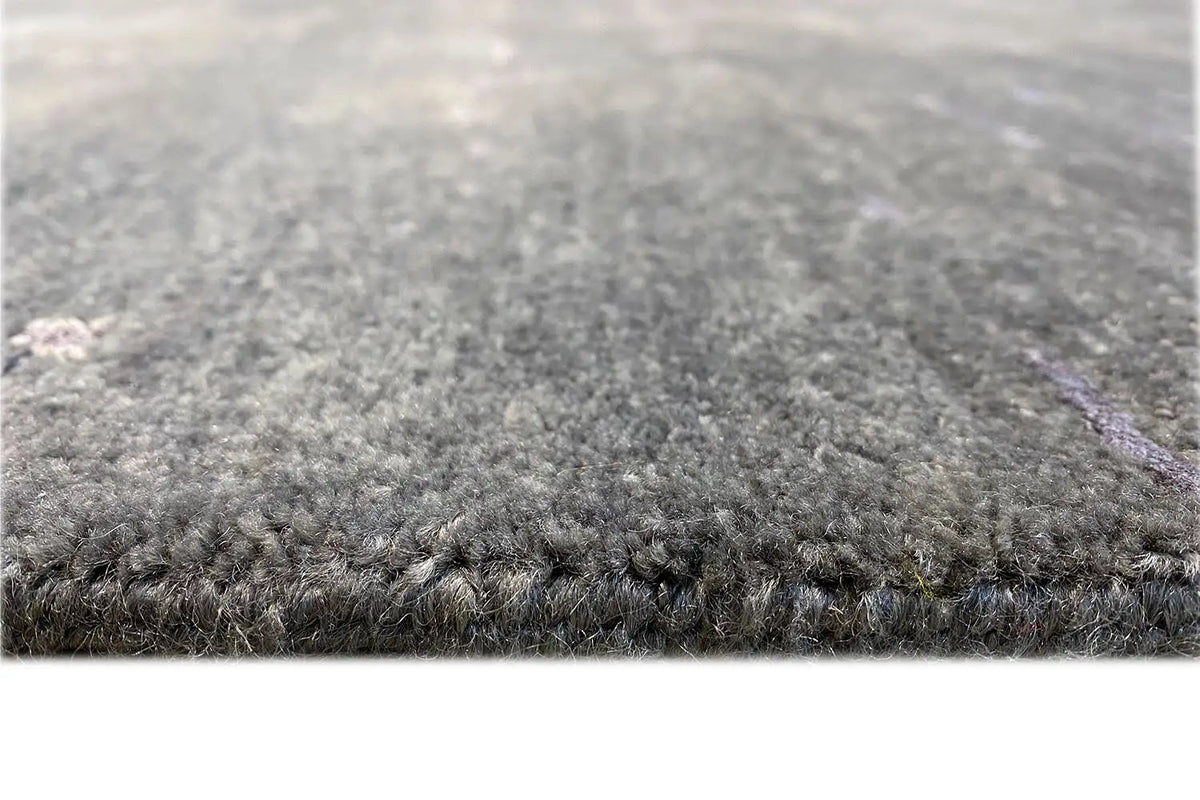 Designer rug with short pile, dark gray surface, and clean edge