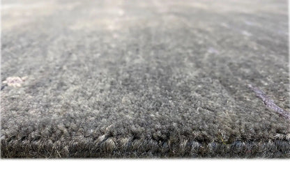 Designer rug with short pile, dark gray surface, and clean edge