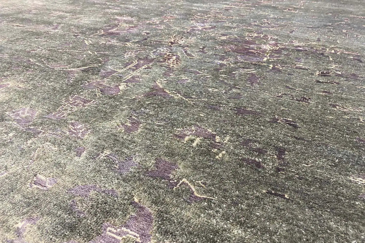 Designer rug, close-up: dark gray abstract pattern with lilac speckles