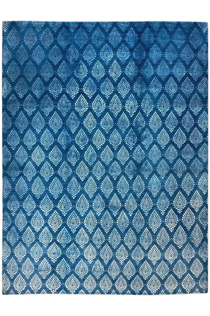 Designer rug with a geometric diamond pattern in blue, highlighted in a lighter shade