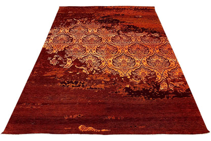 Rectangular rug with a burgundy background and ornate paisley pattern
