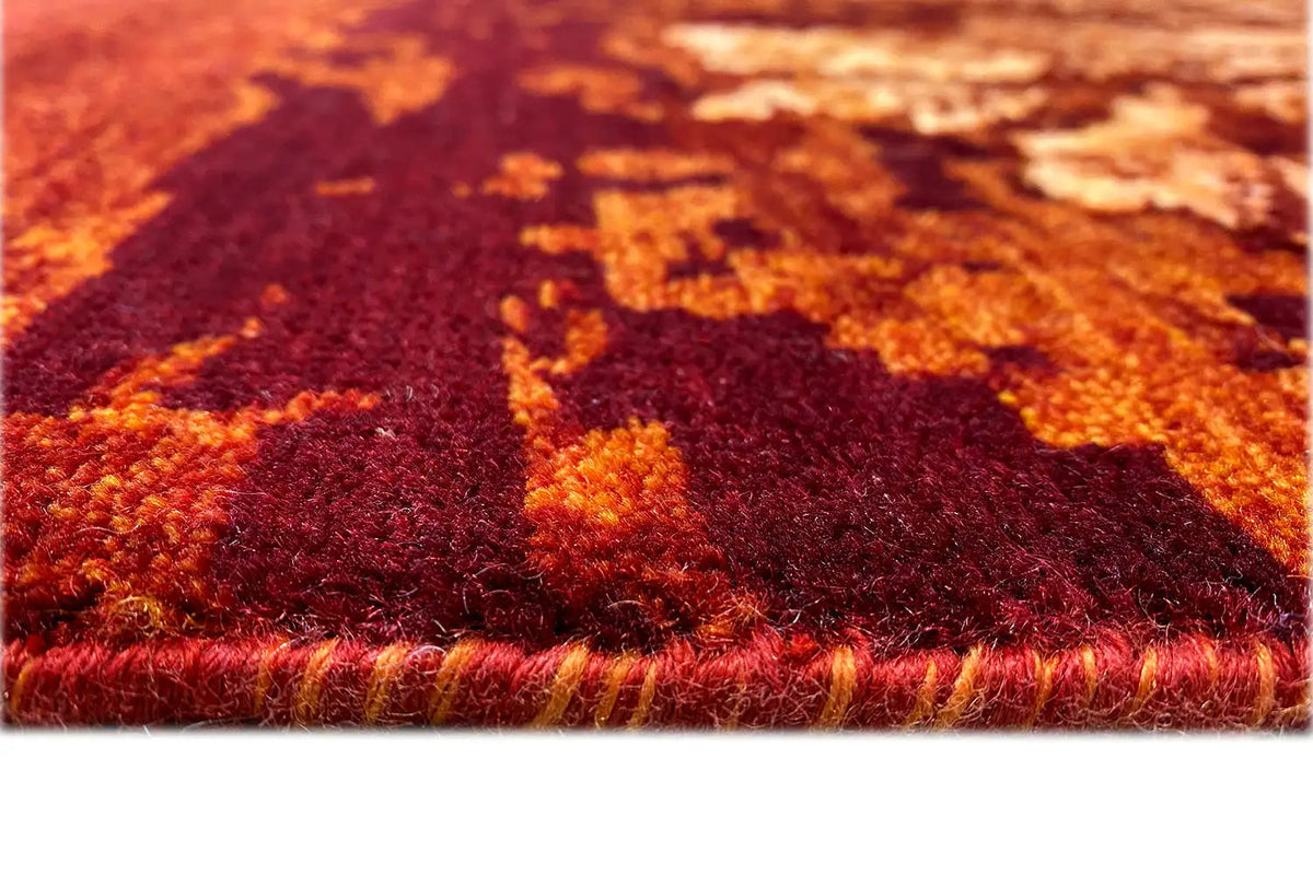 Rug detail: burgundy pile surface with golden-brown ornaments and fringes