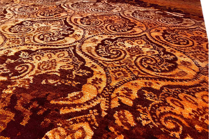 Close-up of the carpet's ornamental pattern in golden brown on a burgundy pile