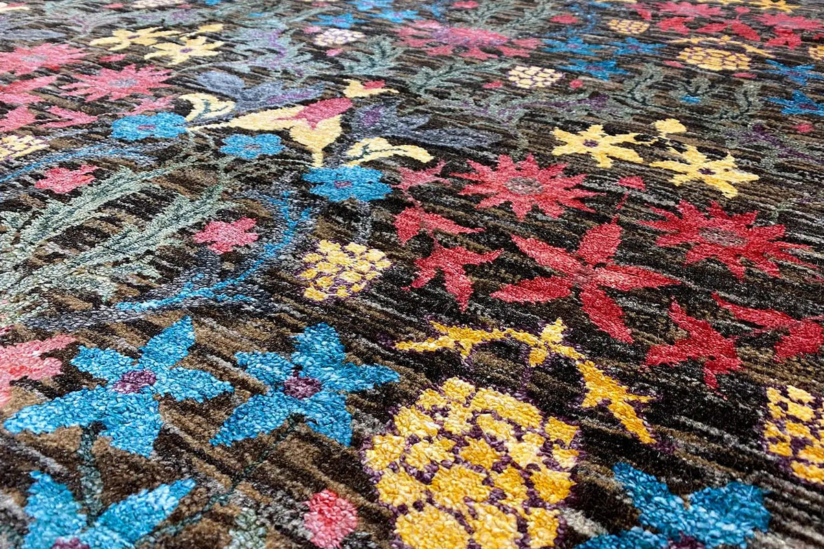Carpet detail with colorful floral ornaments on a dark pile