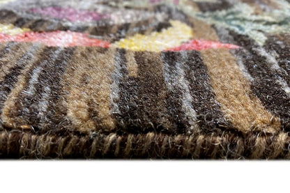 Carpet pile in detail: brown-beige and dark fibers with multicolored flecks