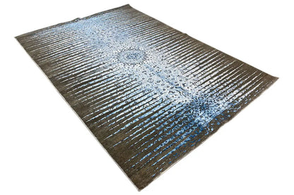 Designer rug: blue pattern in the center, brown field, and fine lines around the edges