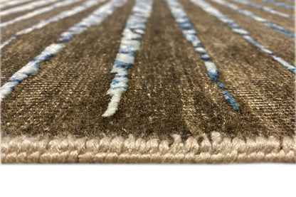 Designer rug with fringes along the edge, brown-blue ornaments, and a bordered trim