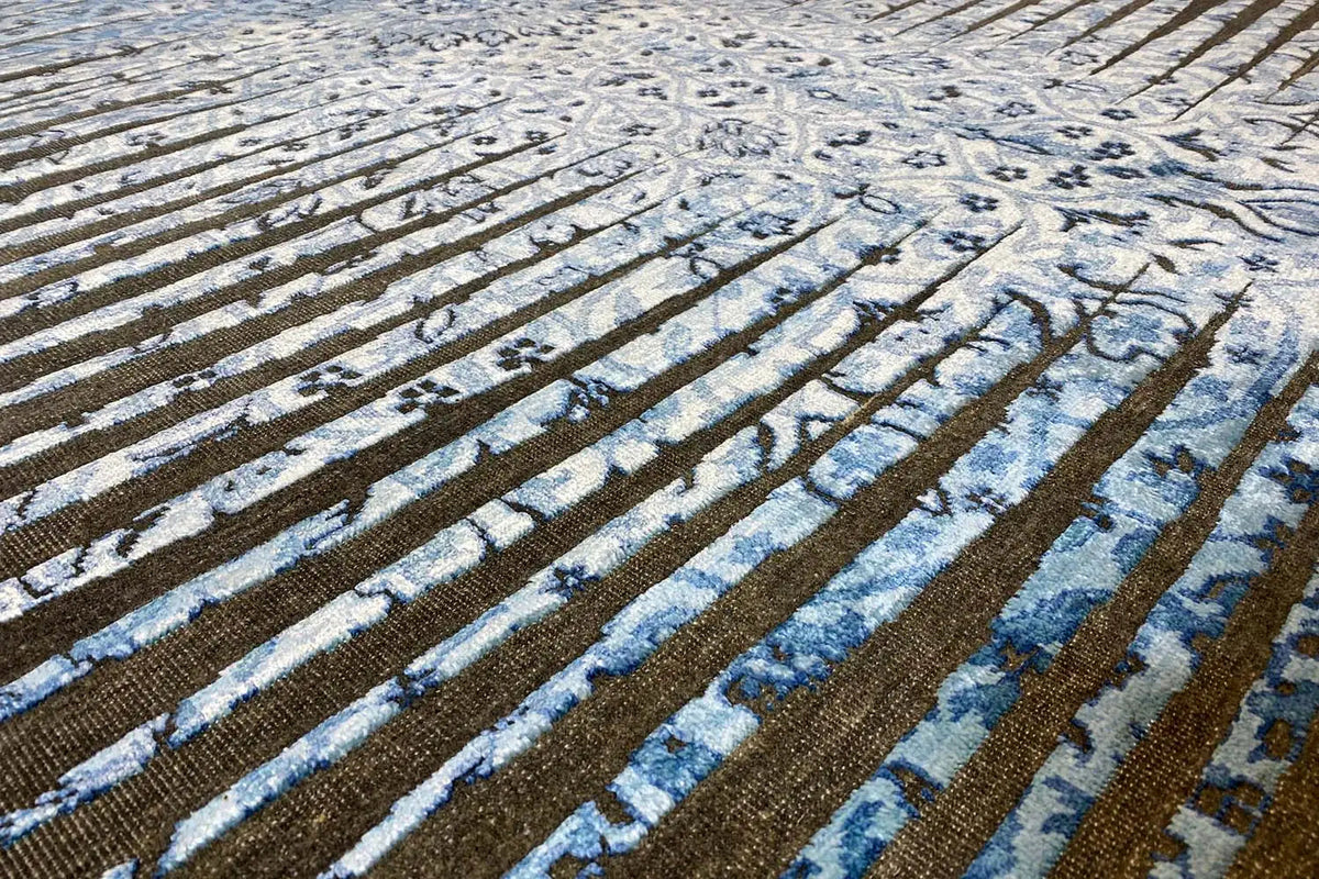 Designer rug in detail: blue striped pattern with ornaments on a brown background