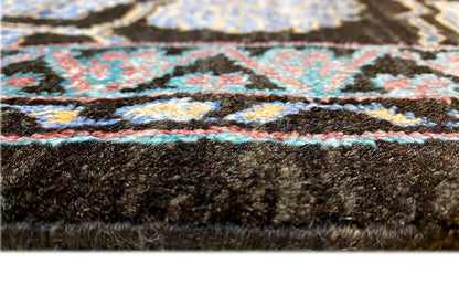 Carpet edge with a blue pattern in the pile and a dark backing, close-up of the edge