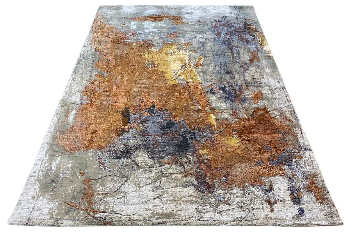 Rectangular designer rug with abstract color blocks in brown, blue, and light gray