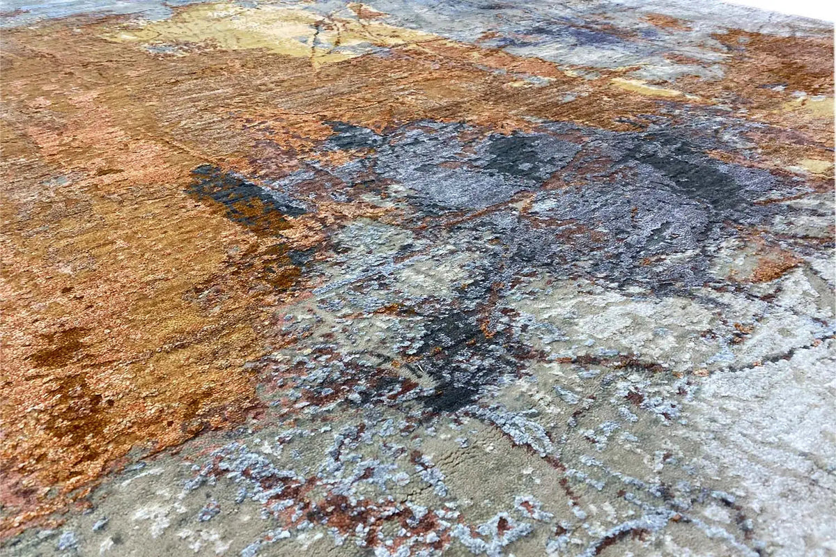 Close-up of a designer rug with a coarse, textured surface in brown, blue, and gray
