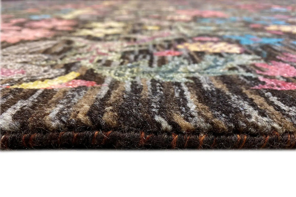 Designer rug close-up of the selvedge: dense pile with a multicolored linear pattern