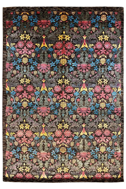 Designer rug with a black background and a colorful ornamental pattern of flowers and stars