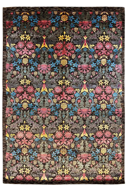 Designer rug with a black background and a colorful ornamental pattern of flowers and stars