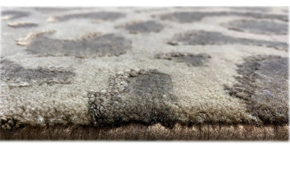 Close-up: carpet pile with a dense, mottled surface in gray and gray-brown