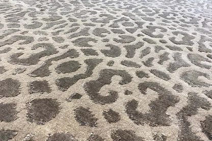Carpet surface with a dense animal pattern in dark gray on a light background