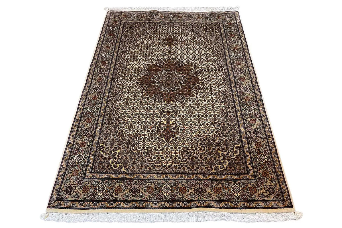 Rectangular rug with decorative border, beige background and dark medallion, fringe