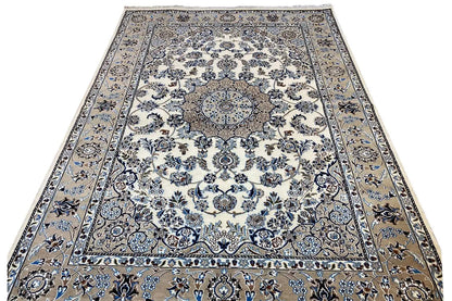 Large rug with a cream-beige base, blue Baroque pattern, and medallion