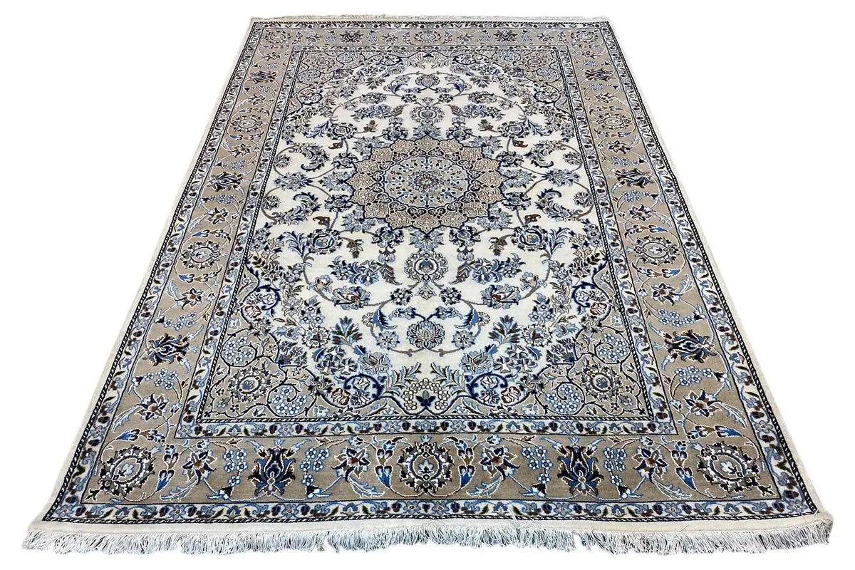 Oriental rug with a large central medallion, blue-and-white ornaments, and fringes along the edge