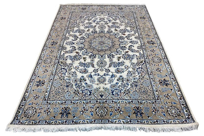 Oriental rug with a large central medallion, blue-and-white ornaments, and fringes along the edge
