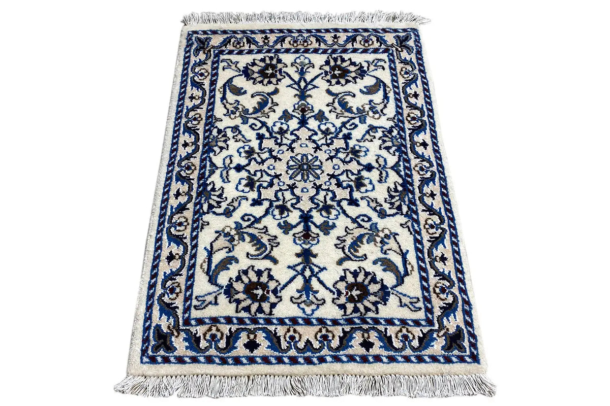 Rectangular rug with blue-and-white ornaments and fringes on all sides