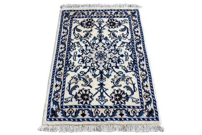 Rectangular rug with blue-and-white ornaments and fringes on all sides