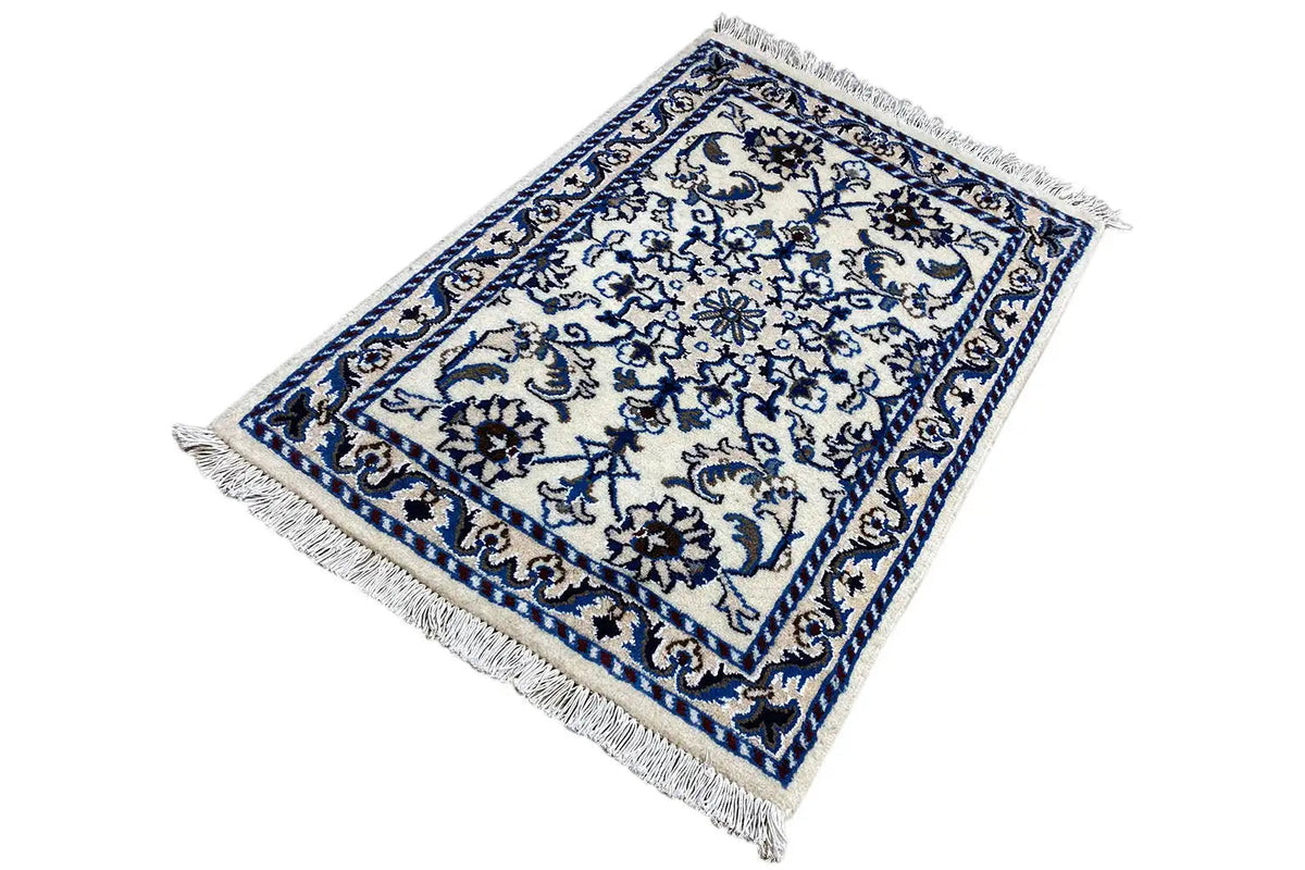 Blue-and-white rug with border ornaments and fringes at the corners