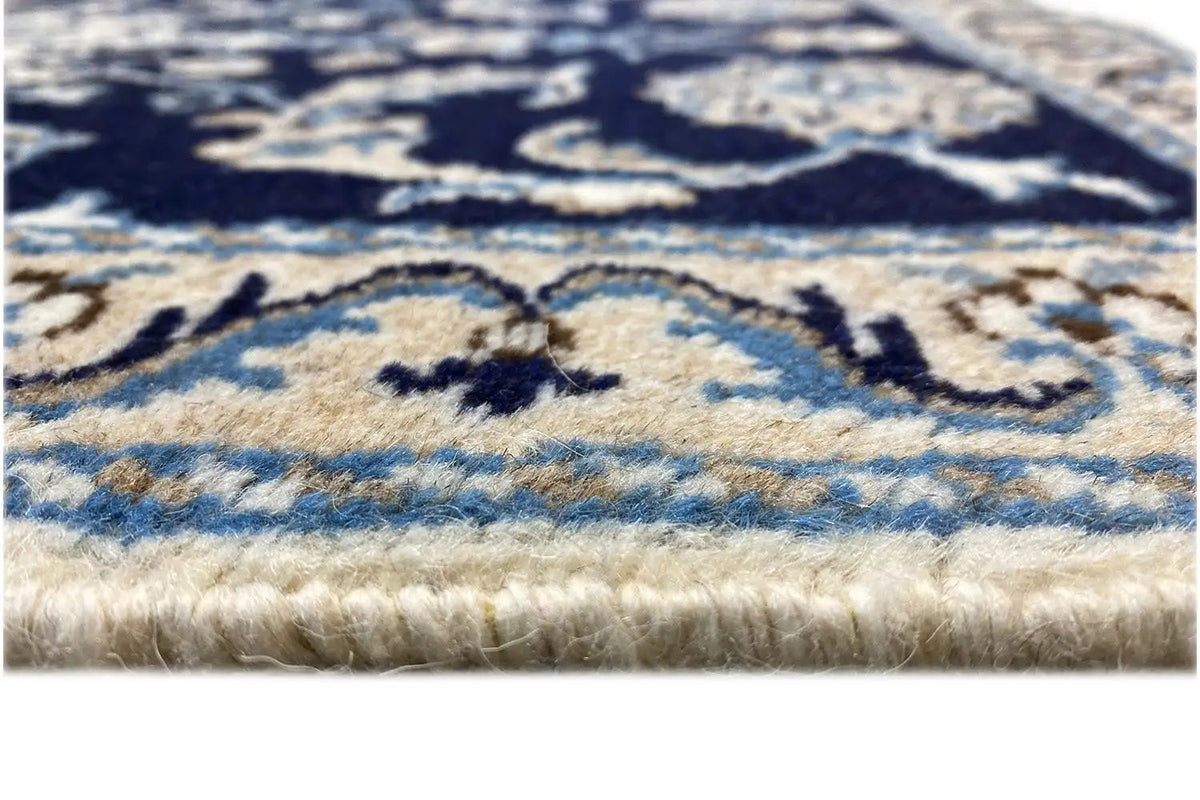 Nain rug detail, blue-beige pattern, visible pile and fringes