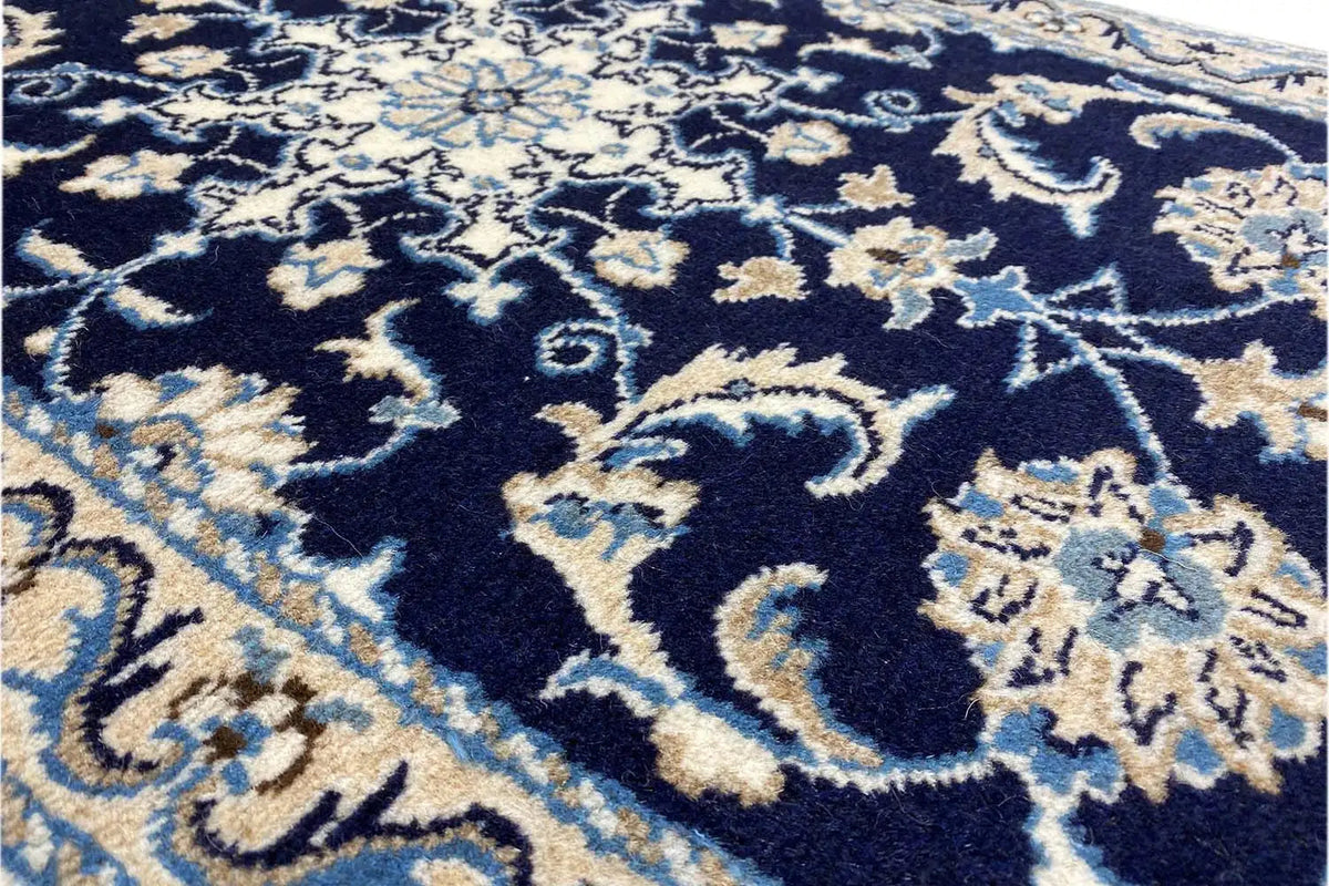 Close-up of a Nain rug, dark blue ornamental pattern with light embellishments